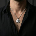 Load image into Gallery viewer, Polished silver tiger necklace with resting feline relief and detailed stripe texture worn on the neck in a close lifestyle frame, highlighting the circular animal form and refined craftsmanship