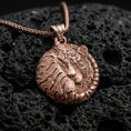 Load image into Gallery viewer, Rose gold plated sleeping tiger necklace with detailed wild cat relief, circular curled body form, and elegant symbolic predator design resting on volcanic rock in an elegant close-up product presentation