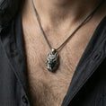 Load image into Gallery viewer, Oxidized polygonal wolf pendant with faceted spirit animal design worn on the neck in a lifestyle jewelry shot, styled against the chest for a bold and modern wilderness statement look