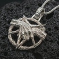 Load image into Gallery viewer, Polished silver bad dream catcher pendant necklace displayed on black volcanic rock, shown in a refined macro product shot with detailed clawed hand, crescent ring, and occult-inspired texture.