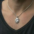 Load image into Gallery viewer, Polished silver howling wolf pendant necklace worn on the neck, shown against the chest in a clean and elegant everyday wear composition.