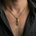 Load image into Gallery viewer, Gold plated octopus pendant necklace worn on the neck, captured on a human model in a premium dark-toned lifestyle frame.