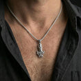 Load image into Gallery viewer, Polished silver octopus pendant necklace worn on the neck, shown against the chest in a clean and elegant everyday wear composition.