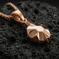 Load image into Gallery viewer, Rose gold plated origami tortoise pendant necklace on dark volcanic rock, photographed in a detailed premium studio macro view.