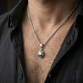 Load image into Gallery viewer, Polished silver origami tortoise pendant necklace worn on the neck, shown against the chest in a clean and elegant everyday wear composition.