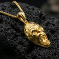 Load image into Gallery viewer, Gold plated gorilla head pendant necklace presented on porous volcanic rock, highlighting the bold animal design in a luxurious close-up jewelry image.