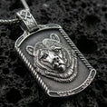 Load image into Gallery viewer, Sterling silver bear pendant necklace with an oxidized finish resting on textured volcanic rock, captured in a close-up premium studio composition.