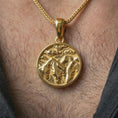 Load image into Gallery viewer, Gold plated mountain landscape pendant necklace worn on the neck, captured on a human model in a premium dark-toned lifestyle frame.