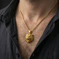 Load image into Gallery viewer, Gold plated tiger lion pendant necklace worn on the neck, captured on a human model in a premium dark-toned lifestyle frame.