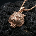 Load image into Gallery viewer, Rose gold plated tiger lion pendant necklace on dark volcanic rock, photographed in a detailed premium studio macro view.
