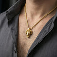 Load image into Gallery viewer, Gold plated ram head pendant necklace worn on the neck, captured on a human model in a premium dark-toned lifestyle frame.
