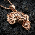 Load image into Gallery viewer, Rose gold plated lion head pendant necklace on dark volcanic rock, photographed in a detailed premium studio macro view.