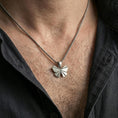 Load image into Gallery viewer, Polished silver origami butterfly pendant necklace worn on the neck, shown against the chest in a clean and elegant everyday wear composition.
