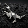 Load image into Gallery viewer, Sterling silver origami kangaroo pendant necklace with an oxidized finish resting on textured volcanic rock, captured in a close-up premium studio composition.