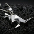 Load image into Gallery viewer, Polished silver origami kangaroo pendant necklace displayed on black volcanic rock, shown in a refined macro product shot with crisp folded geometric detail.