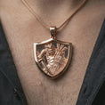 Load image into Gallery viewer, Rose gold plated samurai shield pendant necklace worn on the neck, presented in a close-up lifestyle shot with a refined masculine aesthetic.