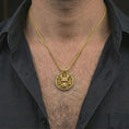Load image into Gallery viewer, Gold plated samurai skull pendant necklace worn on the neck, captured on a human model in a premium dark-toned lifestyle frame.