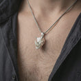 Load image into Gallery viewer, Polished silver rhinoceros head pendant necklace worn on the neck, shown against the chest in a clean and striking everyday wear composition.
