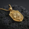 Load image into Gallery viewer, Gold plated wolf shield pendant necklace presented on porous volcanic rock, highlighting the fierce animal spirit design in a luxurious close-up jewelry image.