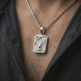 Load image into Gallery viewer, Polished silver stag forest pendant necklace worn on the neck, shown against the chest in a clean and striking everyday wear composition.