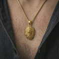 Load image into Gallery viewer, Gold plated roaring lion head pendant necklace worn on the neck, captured on a human model in a premium dark-toned lifestyle frame.