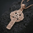 Load image into Gallery viewer, Rose gold plated Celtic cross pendant necklace on dark volcanic rock, photographed in a detailed premium studio macro view.