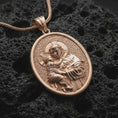 Load image into Gallery viewer, Rose gold plated Saint Anthony pendant necklace on dark volcanic rock, photographed in a detailed premium studio macro view.