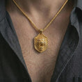 Load image into Gallery viewer, Gold plated roaring lion shield pendant necklace worn on the neck, captured on a human model in a premium dark-toned lifestyle frame.