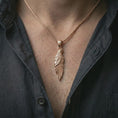 Load image into Gallery viewer, Rose gold plated raven pendant necklace worn on the neck, presented in a close-up lifestyle shot with a refined mythic aesthetic.