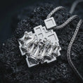 Load image into Gallery viewer, Polished silver chessboard pendant necklace displayed on black volcanic rock, shown in a refined macro product shot with geometric board frame, knight chess piece, and aligned pawns.