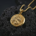 Load image into Gallery viewer, Gold plated lion medallion pendant necklace presented on porous volcanic stone, photographed in a luxurious close-up image that highlights the regal feline motif and detailed mane texture.