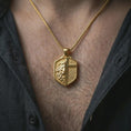Load image into Gallery viewer, A gold plated lion cross pendant worn on the neck, faith-inspired shield jewelry with masculine statement look.