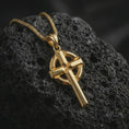 Load image into Gallery viewer, Gold plated Celtic cross pendant necklace presented on dark volcanic stone, photographed in a refined close-up composition that showcases the iconic Irish cross structure and strong metal texture.