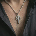 Load image into Gallery viewer, Polished silver Celtic cross pendant necklace worn on the neck, presented in a clean model shot with a classic faith-inspired and heritage-rich appearance.