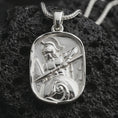 Load image into Gallery viewer, Polished silver Spartan warrior pendant necklace displayed on black volcanic rock, shown in a refined macro product shot with detailed helmet, spear, and shield relief.