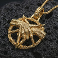Load image into Gallery viewer, Gold plated bad dream catcher pendant necklace presented on porous volcanic rock, highlighting the dark symbolic design in a luxurious close-up jewelry image.