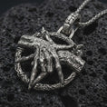 Load image into Gallery viewer, Sterling silver bad dream catcher pendant necklace with an oxidized finish resting on textured volcanic rock, captured in a close-up premium studio composition.