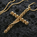 Load image into Gallery viewer, Gold plated skull cross pendant necklace presented on porous volcanic rock, highlighting the dramatic skeletal cross design in a luxurious close-up jewelry image.
