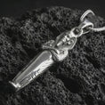 Load image into Gallery viewer, Polished silver King Tut pendant necklace displayed on black volcanic rock, shown in a refined macro product shot with detailed pharaoh head and serpent relief.