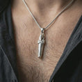 Load image into Gallery viewer, Polished silver King Tut pendant necklace worn on the neck, shown against the chest in a clean and elegant everyday wear composition.