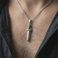Load image into Gallery viewer, Oxidized King Tut pendant necklace worn on the neck, styled in a dark lifestyle portrait with an open shirt and masculine presentation.