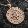 Load image into Gallery viewer, Rose gold plated compass pendant necklace on dark volcanic rock, photographed in a detailed premium studio macro view.