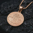 Load image into Gallery viewer, Rose gold plated Pope Innocent coin pendant necklace presented on textured volcanic stone, showcasing the round papal coin silhouette and intricate religious-historical detailing in a refined macro studio shot.