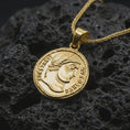 Load image into Gallery viewer, Gold plated Emperor Constans coin pendant necklace photographed on porous black volcanic stone, emphasizing the imperial side-profile bust and engraved Latin lettering in a luxury historical jewelry composition.