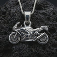 Load image into Gallery viewer, Polished silver sportbike motorcycle pendant necklace displayed on black volcanic rock, shown in a refined macro product shot with angular fairing, wheel, and exhaust detail.