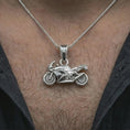 Load image into Gallery viewer, Polished silver sportbike motorcycle pendant necklace worn on the neck, shown against the chest in a clean and dynamic everyday wear composition.