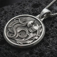 Load image into Gallery viewer, Sterling silver Art Nouveau woman pendant necklace with an oxidized finish resting on textured volcanic rock, captured in a close-up premium studio composition.