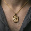 Load image into Gallery viewer, Gold plated Roman soldier pendant necklace worn on the neck, captured on a human model in a premium dark-toned lifestyle frame.