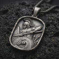 Load image into Gallery viewer, Sterling silver Roman soldier pendant necklace with an oxidized finish resting on textured volcanic rock, captured in a close-up premium studio composition.