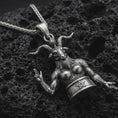 Load image into Gallery viewer, Sterling silver Baphomet pendant necklace with an oxidized finish resting on textured volcanic rock, captured in a close-up premium studio composition.